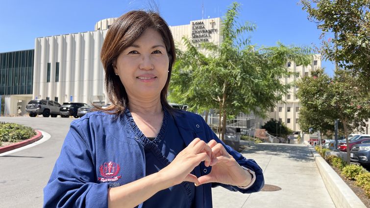 Zoe Lee makes a heart with her hands on Loma Linda University Health Campus