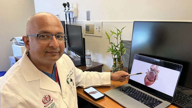 Kamal M. Kotak, MD, a cardiac electrophysiologist at Loma Linda University International Heart Institute, points to an interactive rendering of a human heart.