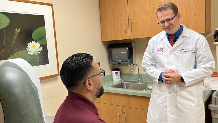 Medical oncologist Joel Brothers, MD, in his clinic at Loma Linda University Cancer Center where he consults with patients with prostate cancer about various treatment options.  