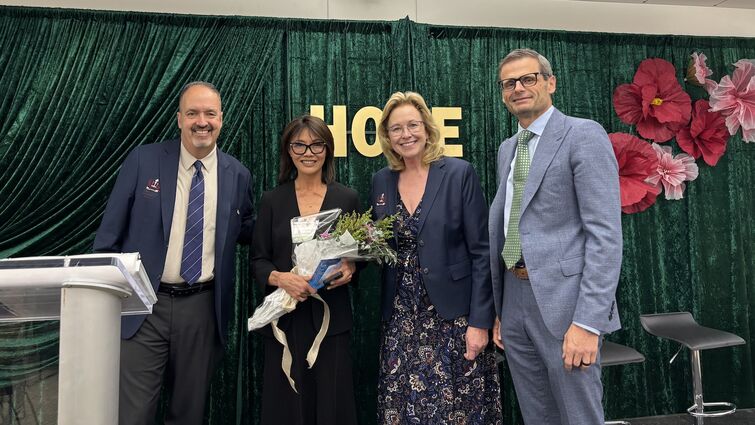 Four people smile at the camera at the Seeds of Hope event