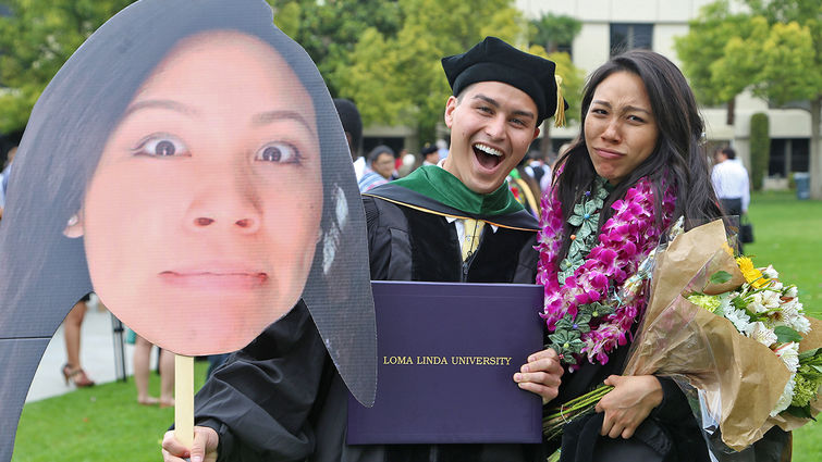 As these two recent graduates affirm, getting an education is serious business! Most of the time, anyway.