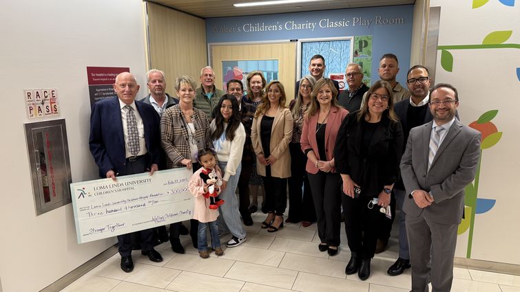 WCCC committee and LLUCH staff group together for a photo while holding check donation