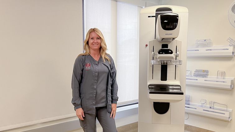 Heather Underwood, a mammography technician, stands next to a mammography machine at LLUH Women's Imaging Center. She encourages patients to relax and communicate during their mammogram appointments. Heather Underwood, a mammography technician, stands next to a mammography machine at LLUH Women's Imaging Center.