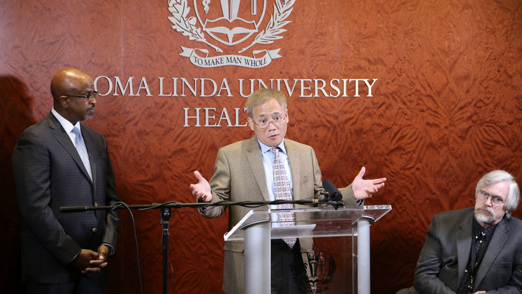 Lubo Zhang, PhD, director of the Center for Perinatal Biology, makes a point at the March 29 press conference. With him (from left): Garrett Caldwell, DMin, executive director of public affairs, and William Pearce, PhD, professor of physiology.