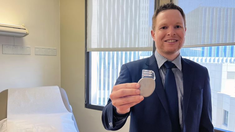 Brennan Rigby, MD, an electrophysiology fellow at Loma Linda University Medical Center, holds a defibrillator.