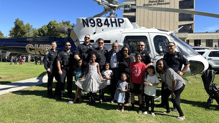 kids and law enforcement standing in front of helicopter