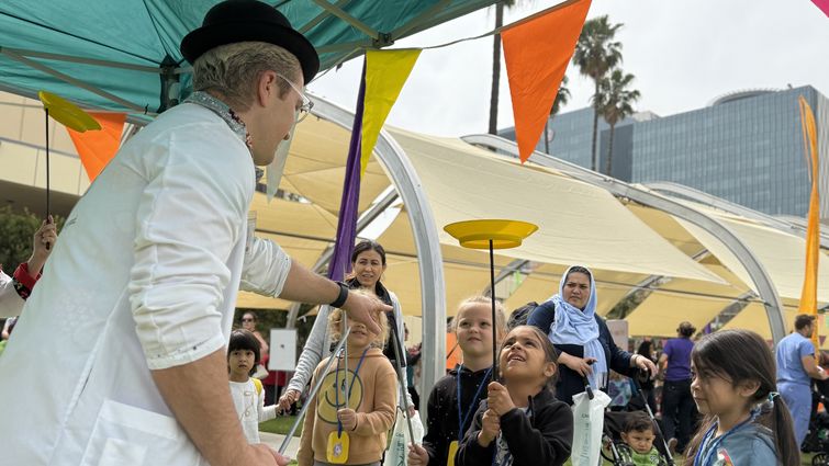 Young kids learn how to balance plates with red nose docs