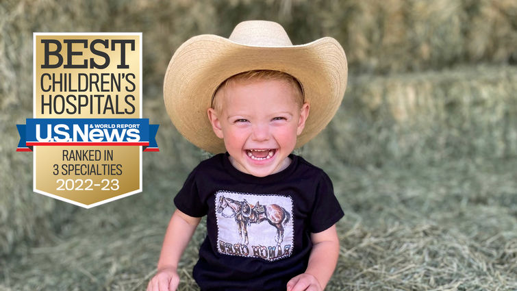 young smiling boy in cowboy hat