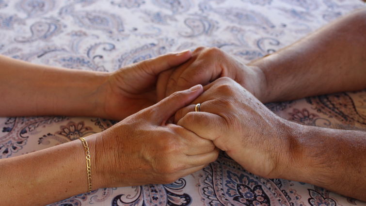 Couple holds hands