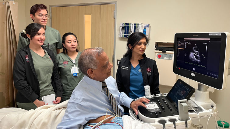 Dr. Ramesh Bansal performs an echocardiogram while International Heart Institute care team members observe.