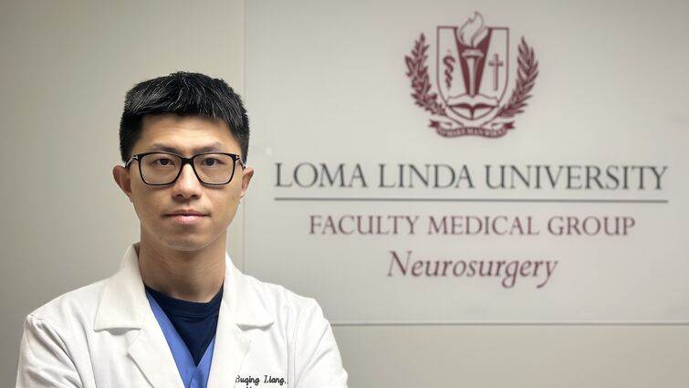 Spine surgeon addresses the top six ways to prep for spine surgery Doctor with a white coat stands in front of the Loma Linda University Neurosurgery sign with his arms crossed