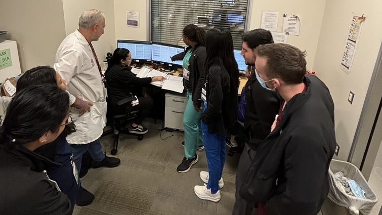 Dr. Bannout, in a white coatm with a group of students and residents during a teaching session about seizures 