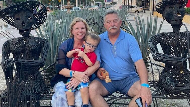 family sitting on a bench during vacation