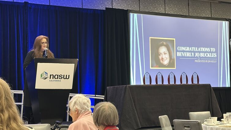 Dr. Buckles standing at podium