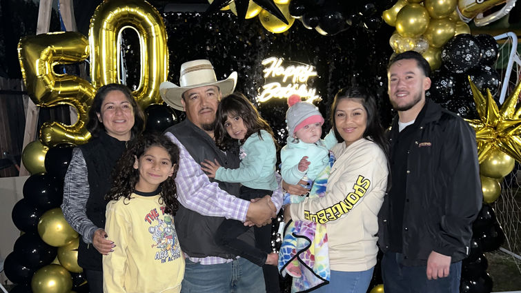 Ramiro Brito Sanchez celebrates his 50th birthday surrounded by loved ones, including his wife, children, and grandchildren.