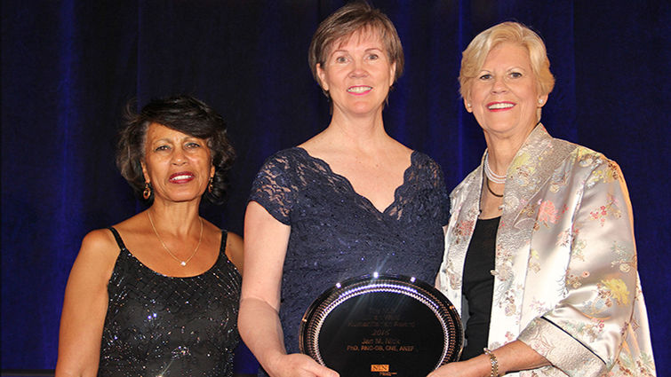 Jan Nick (center) receives her award from Beverly Malone, PhD, RN (left), CEO of the National League for Nursing, and Anne Bavier, PhD, RN, president of the league’s board of governors.