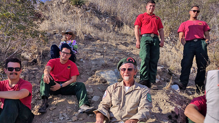 Surrounded by supportive Bear Divide Hotshots and his wife, Sharon, Loop Fire survivor Jerry Smith, center, returned to the site of the fatalities during a 50-year commemorative event Nov. 1 attended by hundreds of firefighters.