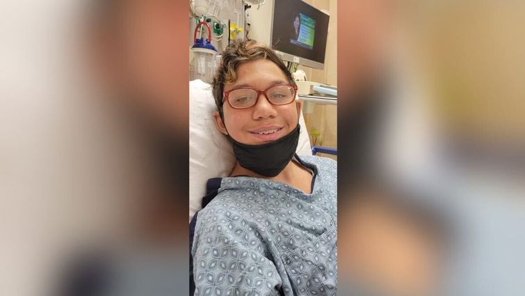 Teen boy smiling for photo after surgery