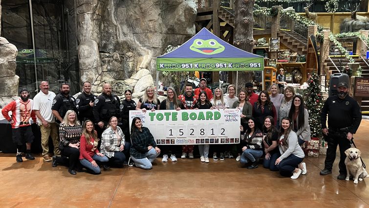 Volunteers and participants gather for a check presentation