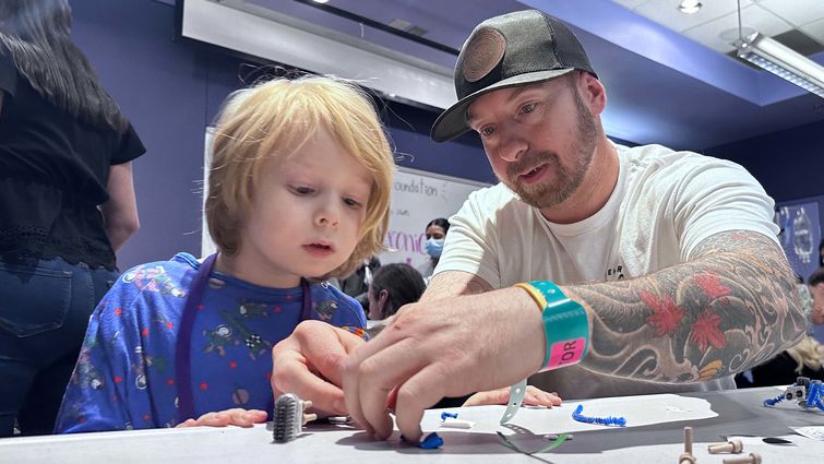 Boy and his dad play create robotic bug