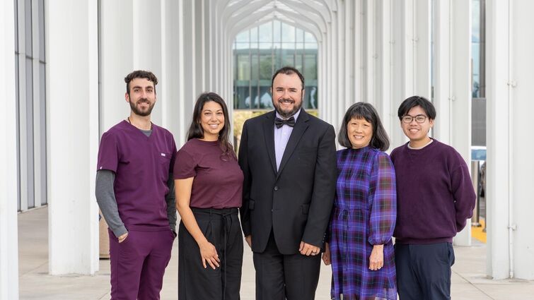 infectious disease team of three men and two women standing outside