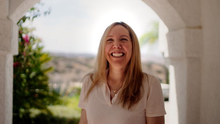 Patricia Bianchi smiles at her home.