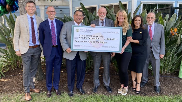 Hospital and government officials with large check 