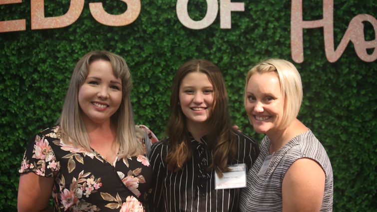 Grace posing with her mother and therapist at the 2022 Seeds of Hope fundraiser