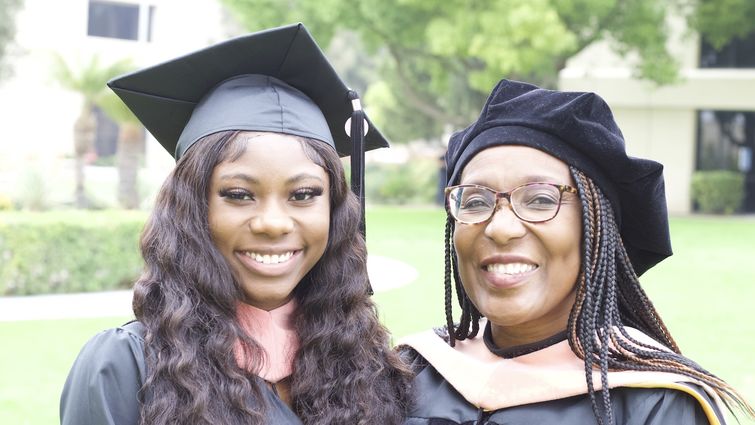 two Black women in graduation regalia