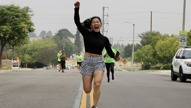 Woman celebrating at 5k finish line