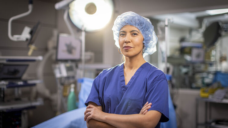 Dr. Andrea Salcedo stands facing camera in operation room