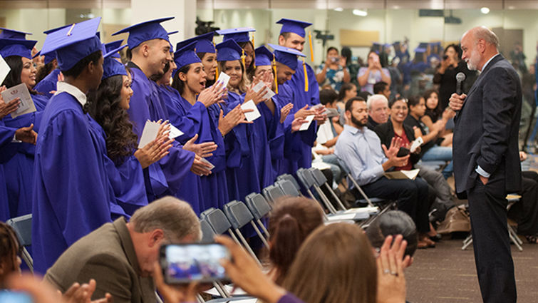 The pioneering first graduates of San Manuel Gateway College cheer as Richard Hart MD, DrPH, president of Loma Linda University Health, pronounces them alumni of Loma Linda University. Commencement ceremony for San Manuel Gateway College Class of 2017 graduates