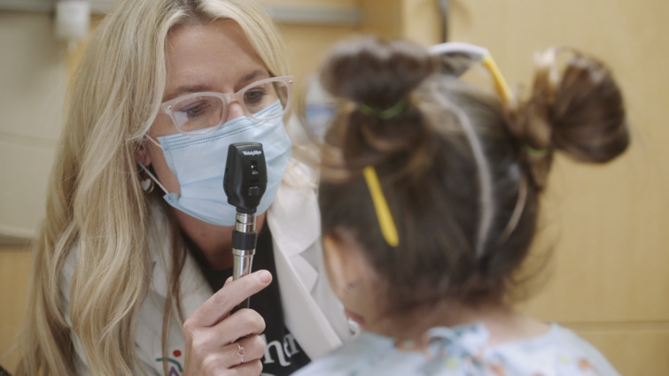 female doctor examines pediatric female patient