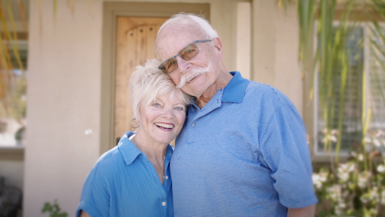 a woman and man smile together while holding each other