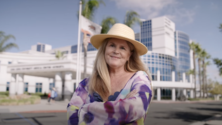 Breast cancer affects one in eight women in the United States A woman in a floral dress stands in front of Loma Linda University Healthy Murrieta Center