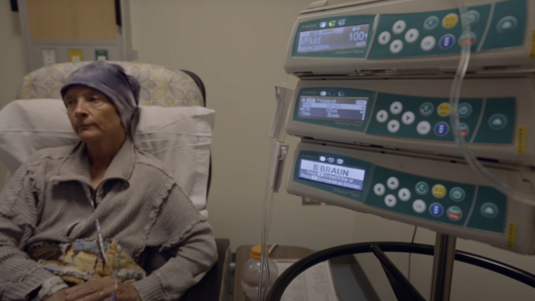 a woman sits in a chair while receiving a medical treatment 