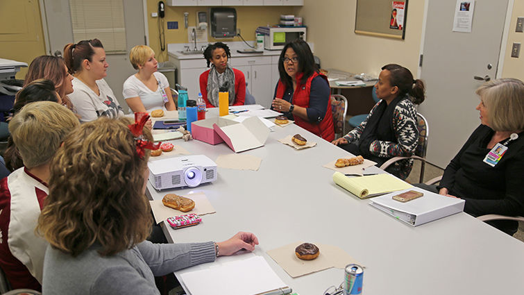 At the monthly professional governance committee of the OB nursing staff, nurses discuss ways to improve patient care. Holly Yelorda, Magnet® coordinator, is fourth from right. Magnet Team