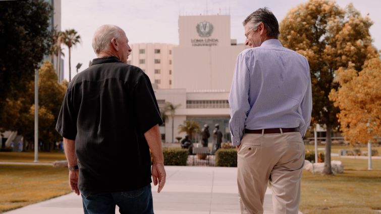 Thomas Hendrix (left) and Herbert Ruckle, MD, (right) reflect on their partnership throughout Hendrix’s battle against prostate cancer. Thomas Hendrix and Dr. Herbert Ruckle talk and walk together on Loma Linda University's campus.