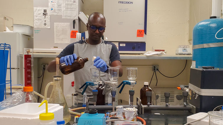 Thomas Hile, PhD, MSc, an LLU affiliated researcher, prepares water samples for testing in a laboratory.