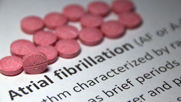 Red pills on piece of paper that says atrial fibrillliation