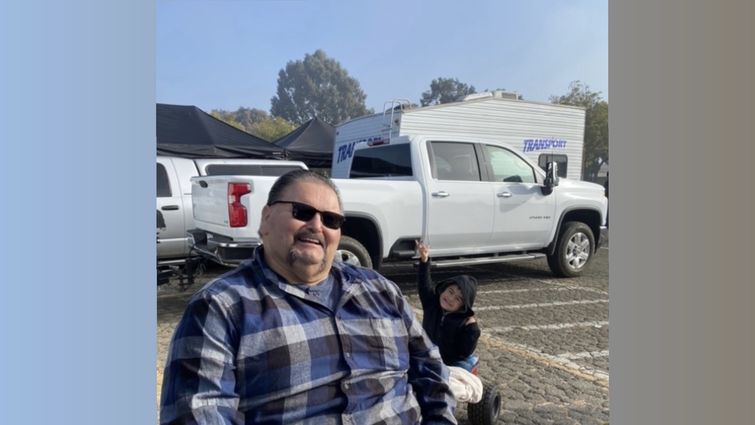 Armando Ortiz at a car show with his grandson