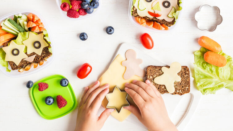 hands making school lunches