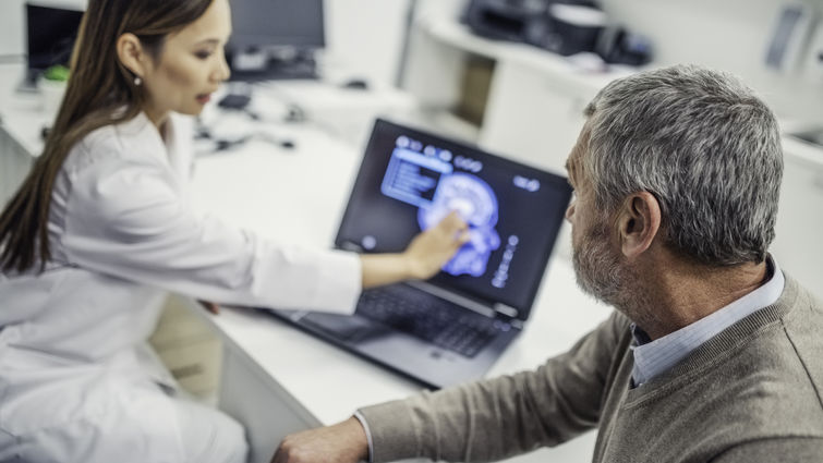 doctor shows patient brain scan