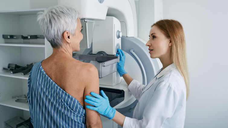  Senior woman having mammography scan at hospital with medical technician