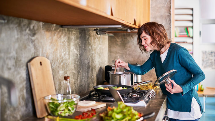 woman in the kitchen smelling her cooking food