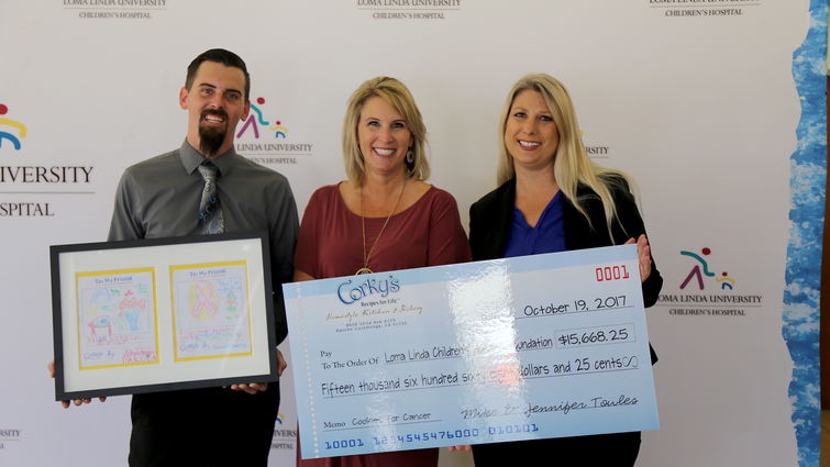 From left, Corky’s representatives Darin Handlin and Jennifer Towels along with Tiffany Hoekstra from LLUCH Foundation at the check presentation on Oct. 19.
