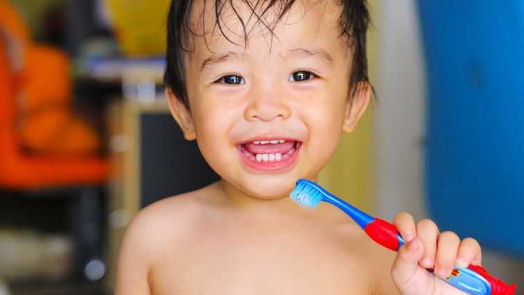 child holding tooth brush