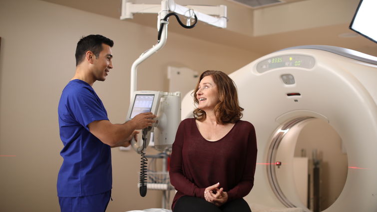 Patient speaking with provider before undergoing CT scan