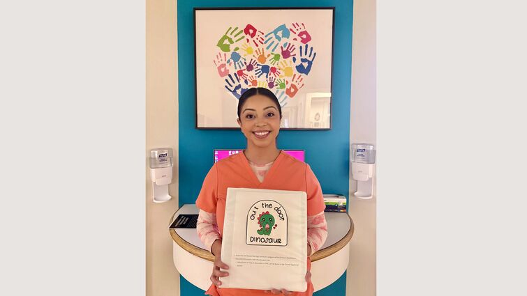 Nurse with dinosaur sign