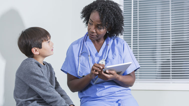 Doctor talking to child patient